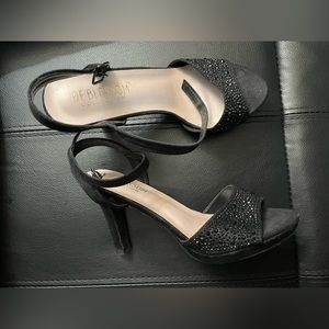 Black heels, never worn .